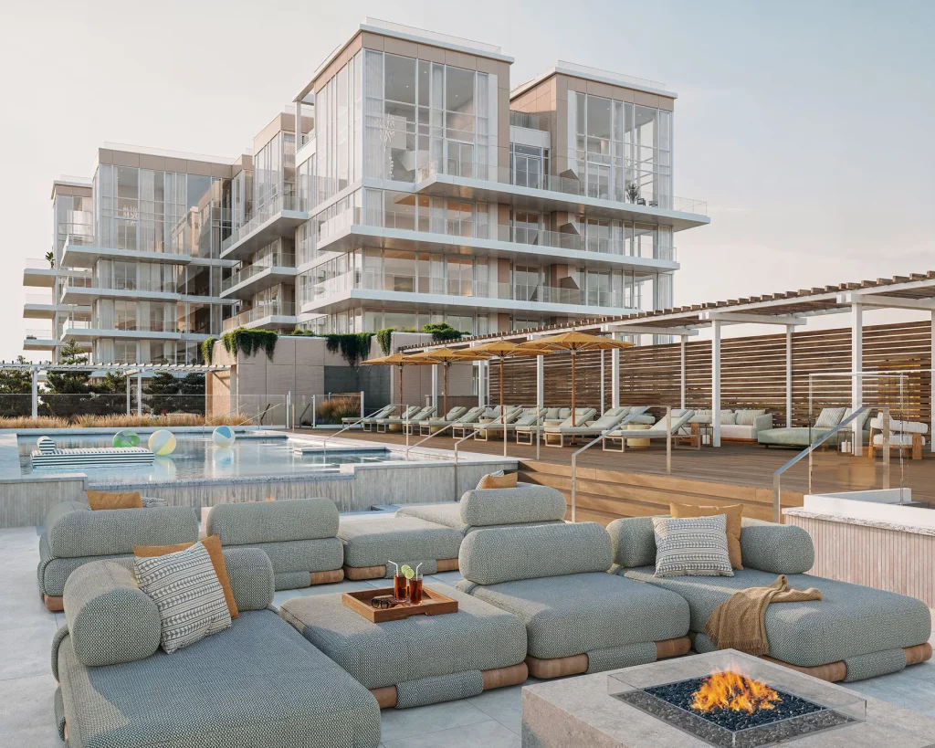 LIDO North Pool Lounge deck with comfortable seating, a modern fire pit, swimming pool and contemporary glass condos in Asbury Park NJ.