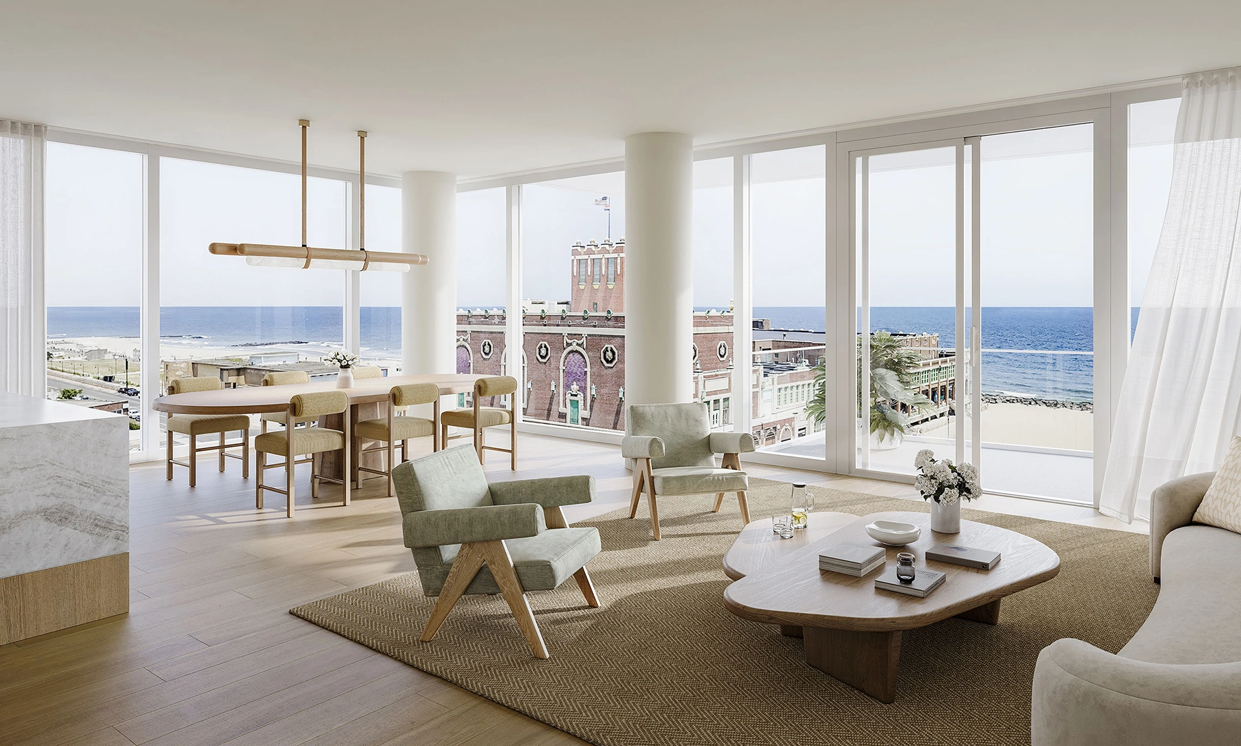 Stunning Asbury Park penthouse at LIDO with lounge seating, dining, and floor-to-ceiling windows overlooking the Atlantic Ocean and Asbury Park attractions.