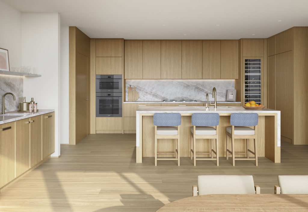 Spacious, modern kitchen at LIDO Condominiums Asbury Park NJ, with wood cabinetry, high-end appliances, marble countertops and a wet bar.