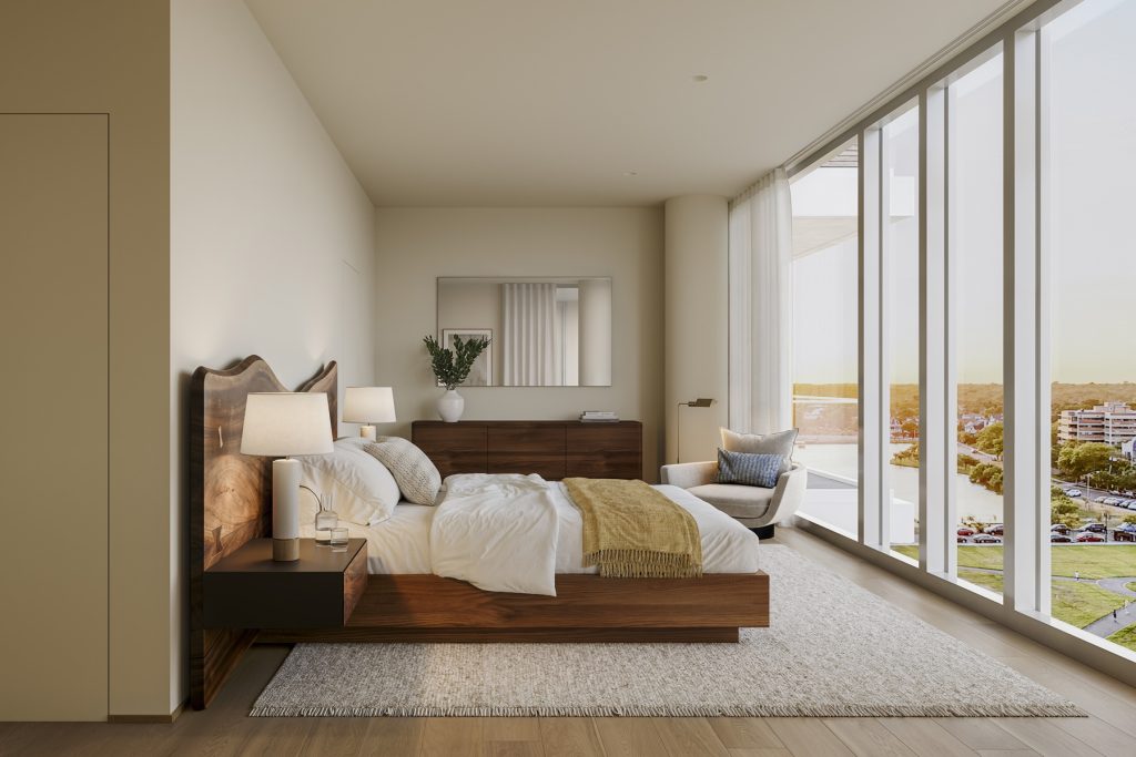 LIDO condos primary bedroom with wood bed frame and floor-to-ceiling windows with views of Asbury Park and the Atlantic Ocean.